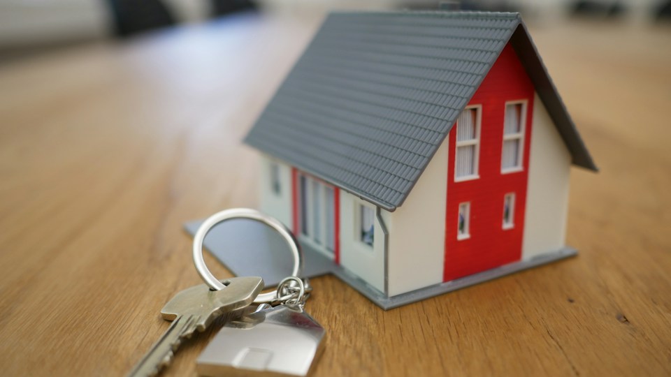 Model house and keys on a desk